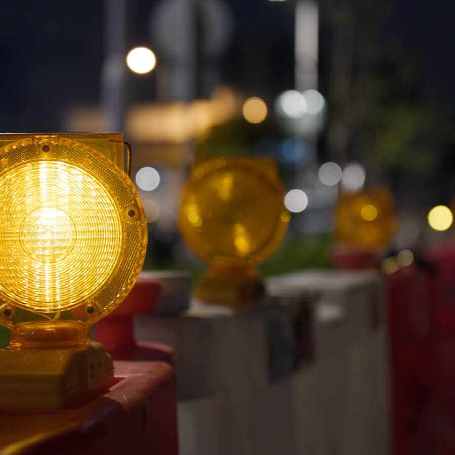 EMPCO LED barricade lights illuminating nighttime construction zone